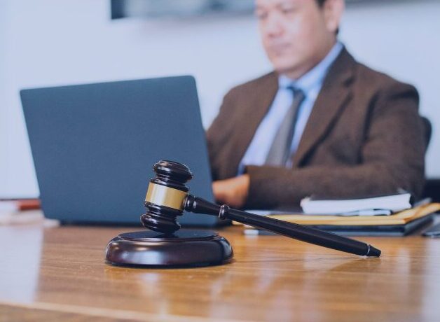 Judge’s gavel on a courtroom desk